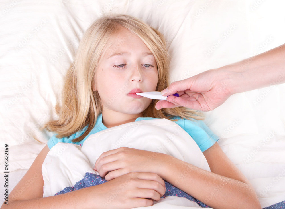 sick girl with a thermometer in mouth