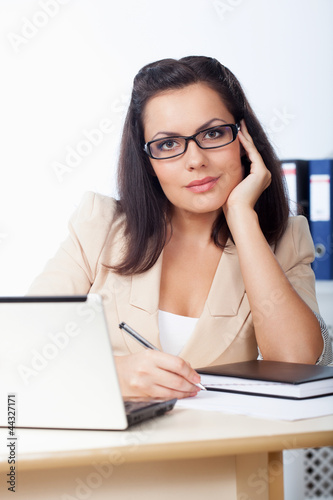 businesswoman sitting behind the desk