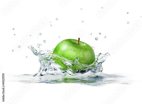 Green apple splashing into water. close up side view, with depth