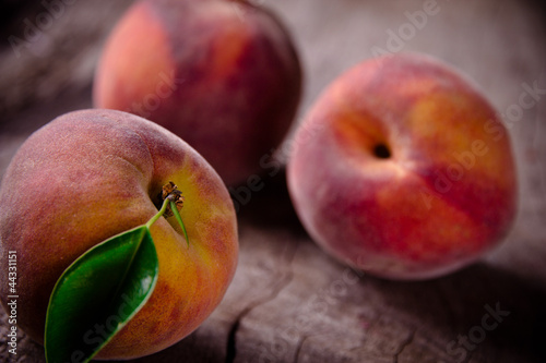 Fresh peaches on wooden table