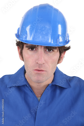 Portrait of a frowning construction worker