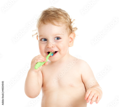 Happy baby child brushing teeth