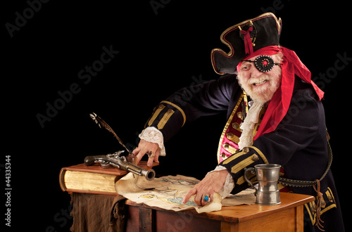 Happy old pirate captain pointing at his treasure map