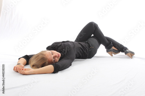 Blonde woman lying on white floor