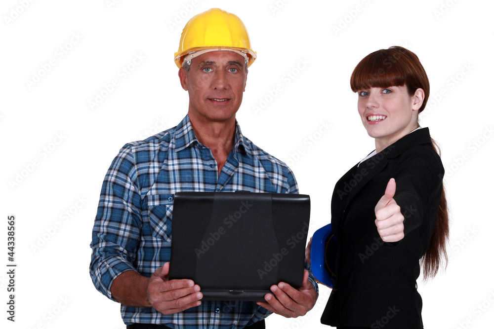 businesswoman and craftsman posing together businesswoman and craftsman posing together