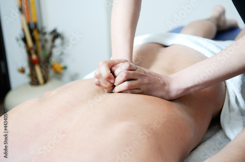 Young man enjoying massage at spa