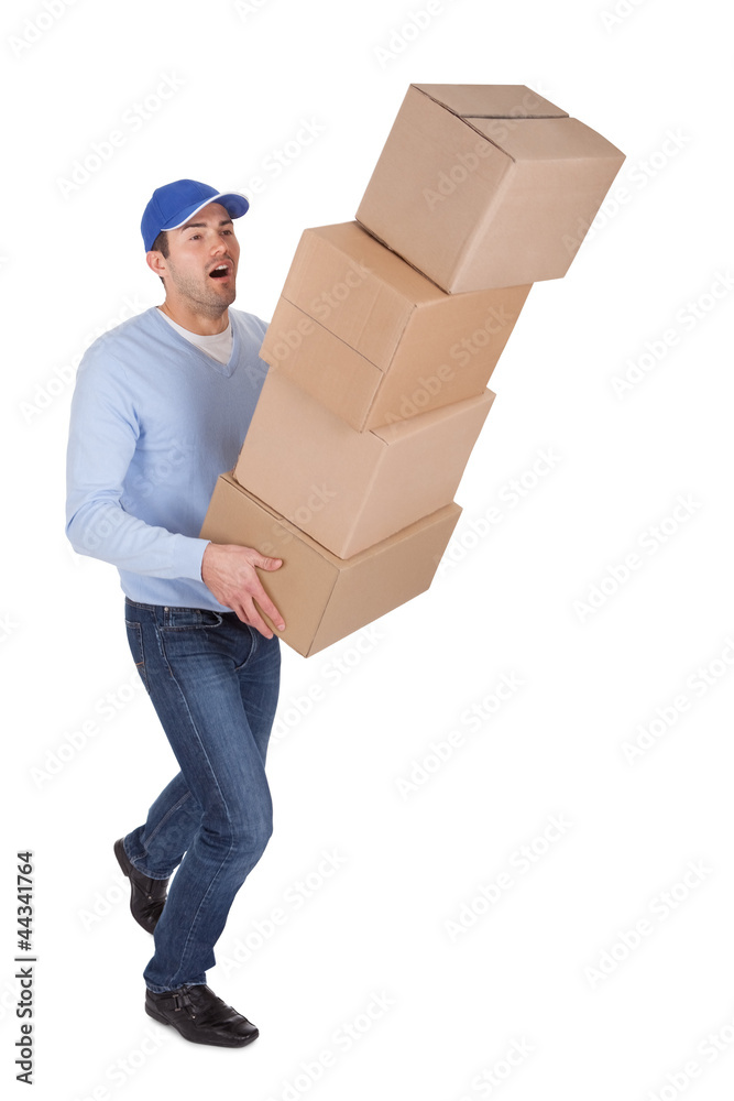 Young delivery man with falling boxes
