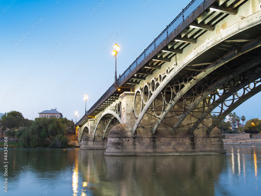 Triana Bridge, the oldest bridge of Seville at twilight