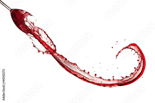 Red wine splashing out of glass, isolated on white
