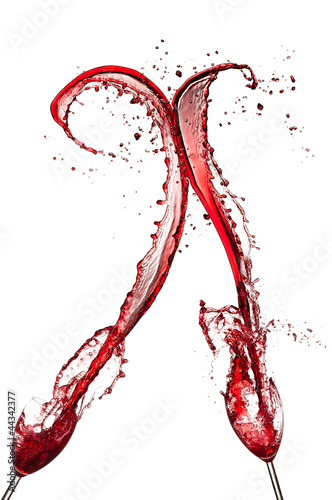 Red wine splashing out of glasses, isolated on white
