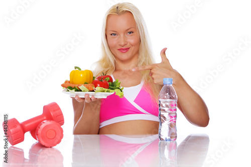 Portrait of sportsman posing on kitchen with food photo