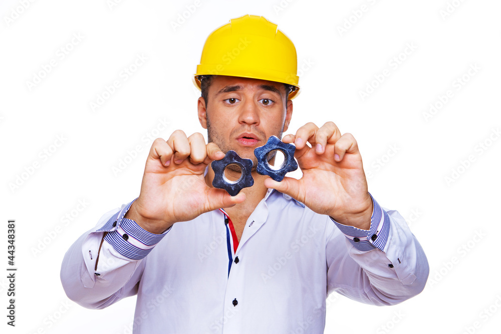 Close portrait of handsome engineer posing in studio with metal Close portrait of handsome engineer posing in studio with metal