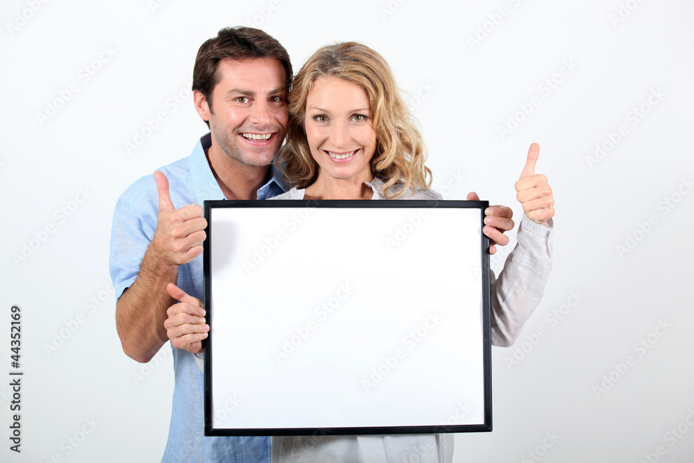 woman and man holding board