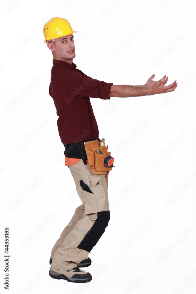 Construction worker holding something heavy Construction worker holding something heavy