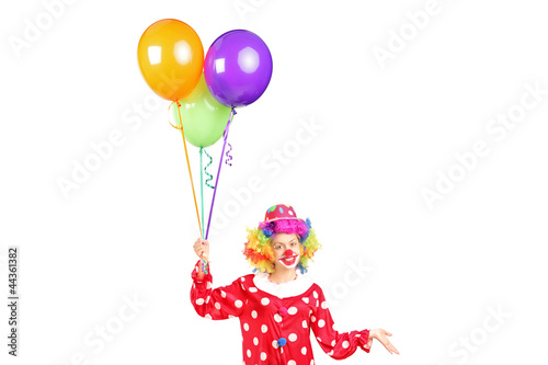 Female clown, happy joyful expression on face, with a bunch of b
