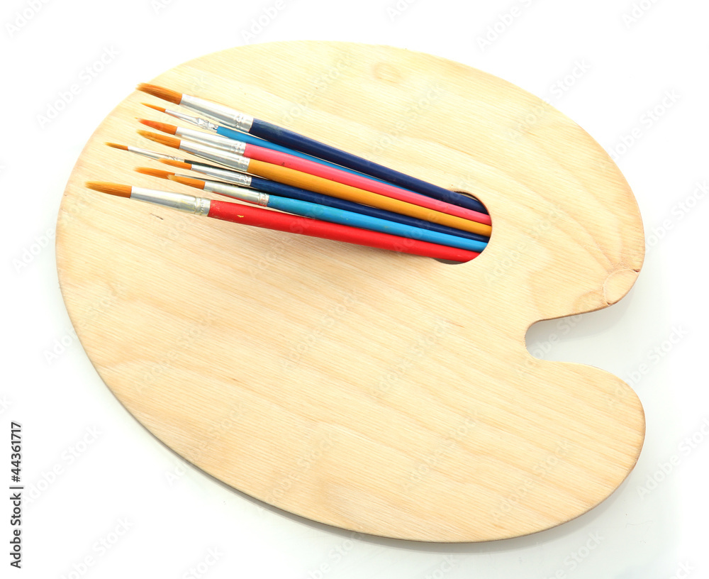 wooden art palette and brushes isolated on white wooden art palette and brushes isolated on white