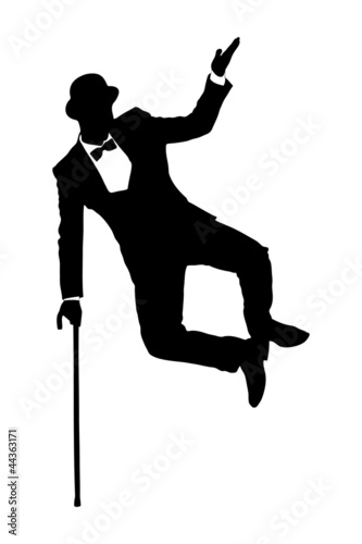 Silhouette of a man in suit holding a cane and dancing