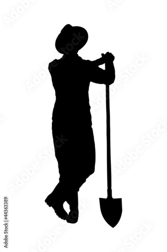 Silhouette of a male farmer holding a shovel