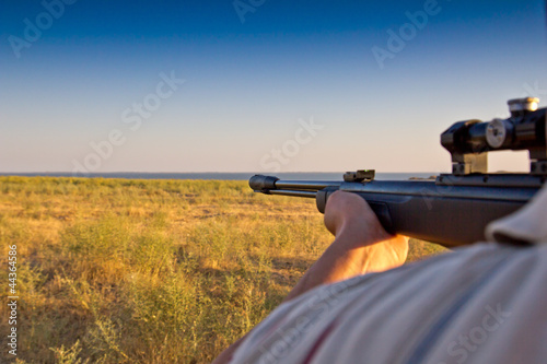 shooting with a gun on the nature photo