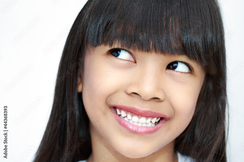 Closeup smiling little child looking up Closeup smiling little child looking up