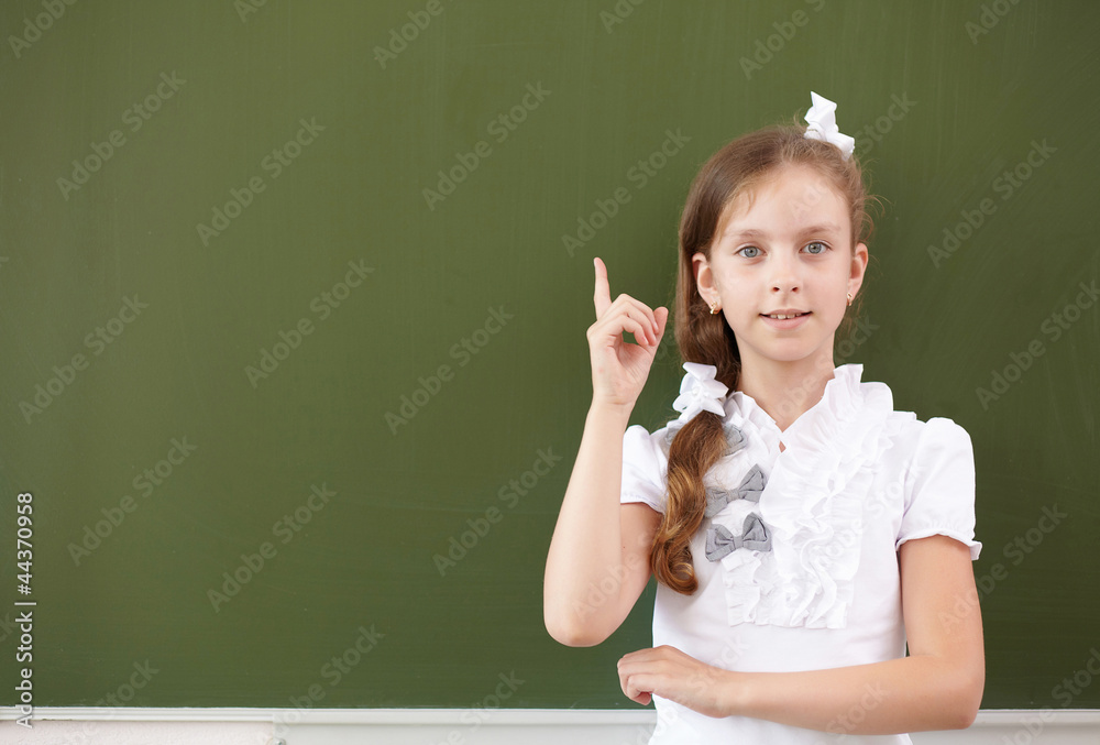 Scoolgirl standing near blackboard Scoolgirl standing near blackboard
