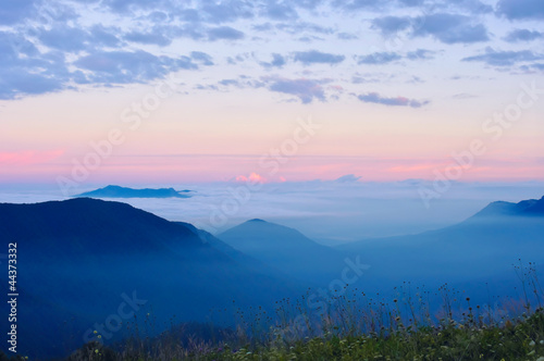 Clouds and fog at sunrise in the mountains