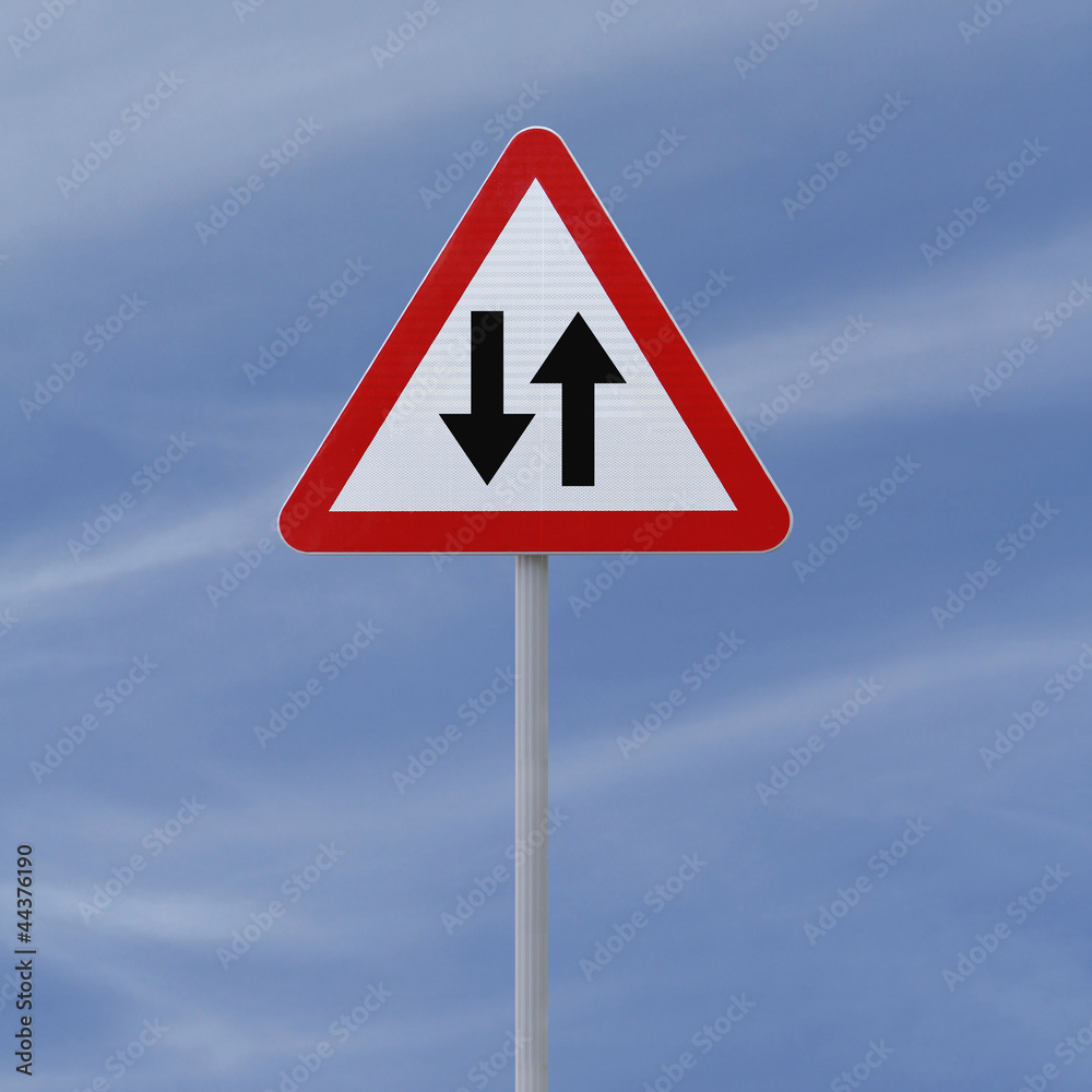 Two way road sign on a blue sky background