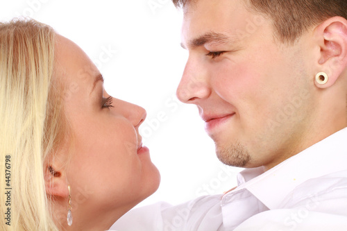 Loving young couple looking at each other against