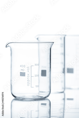 Group of empty laboratory flasks with reflection on the table