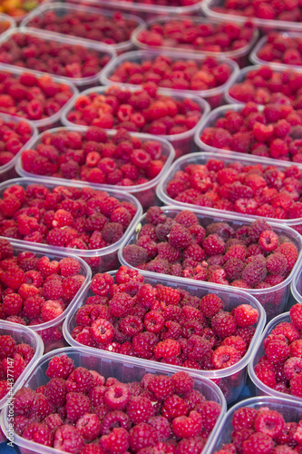 Organic raspberrys on market stand