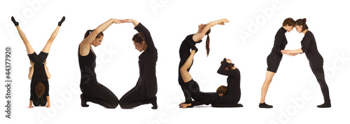 Black dressed people forming YOGA word over white 