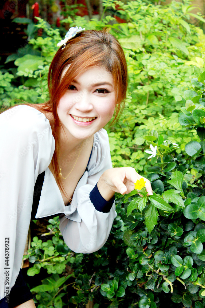 portrait of a beautiful asian woman and small flower