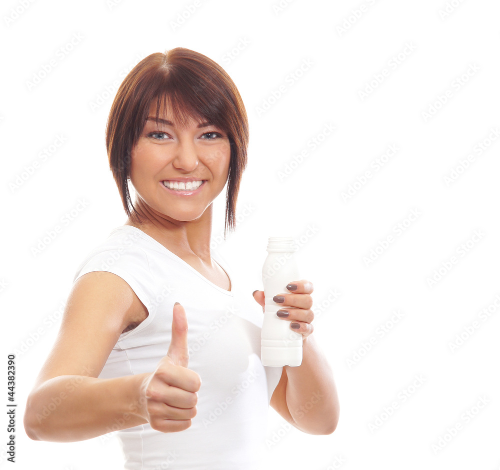 A young brunette Caucasian woman holding a white bottle A young brunette Caucasian woman holding a white bottle