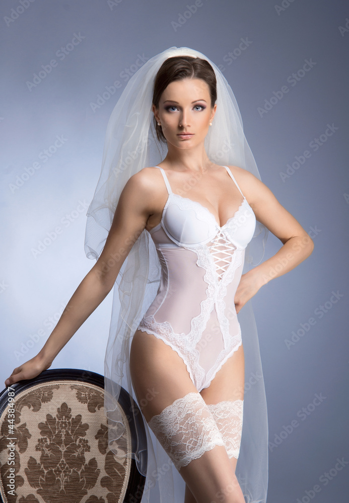 A young brunette bride posing in sexy white lingerie Stock Photo | Adobe  Stock
