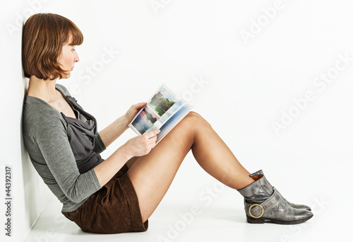 Woman sitting on the floor with book