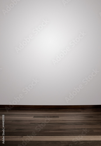 Empty white wall and wooden floor with a spot lights in the wall