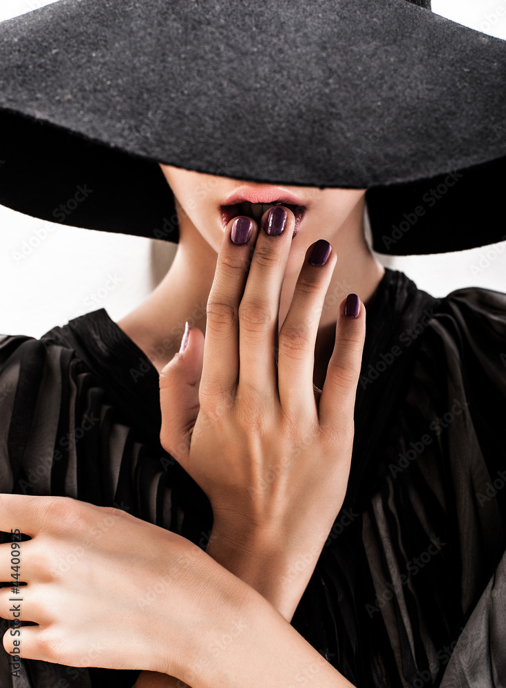 girl in black hat touching face and lips girl in black hat touching face and lips