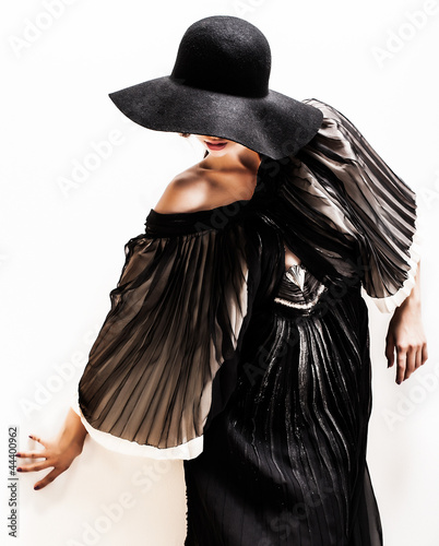 girl in black hat touching face and lips