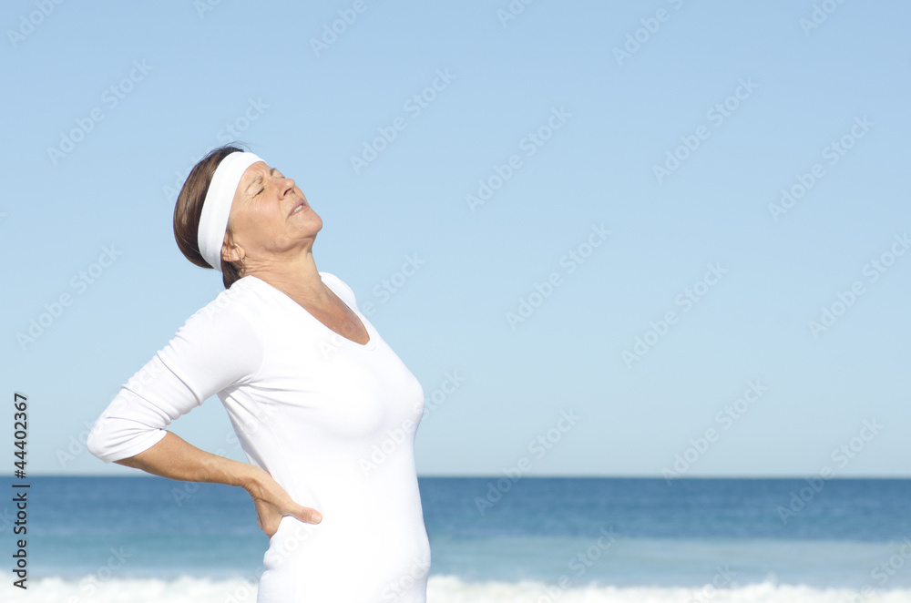 Senior woman suffering backpain sky background Senior woman suffering backpain sky background