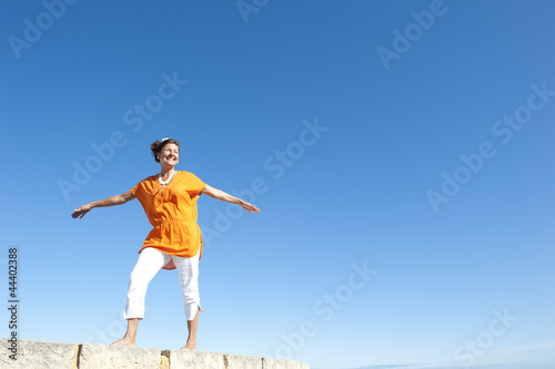 Confident senior woman sky background © roboriginal