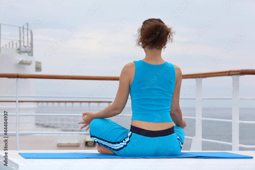 back of woman wearing in sports suit sitting on cruise liner back of woman wearing in sports suit sitting on cruise liner
