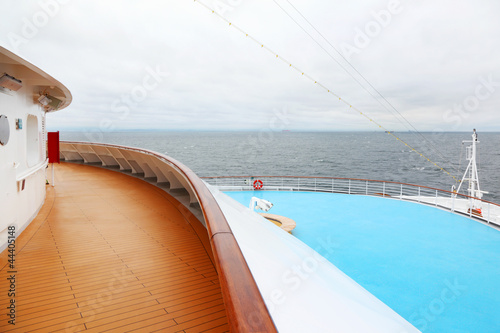 Snout with railing of large cruise ship. View from wooden deck. © Pavel Losevsky