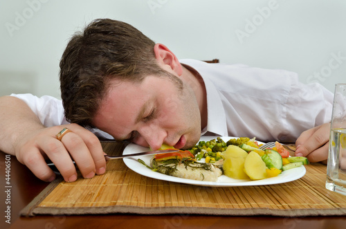 Drunk man sleeping in his dinner plate