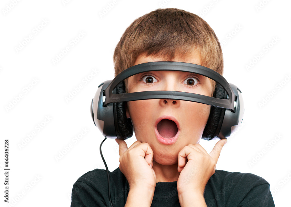 Surprised boy looking through headphones and screams Surprised boy looking through headphones and screams