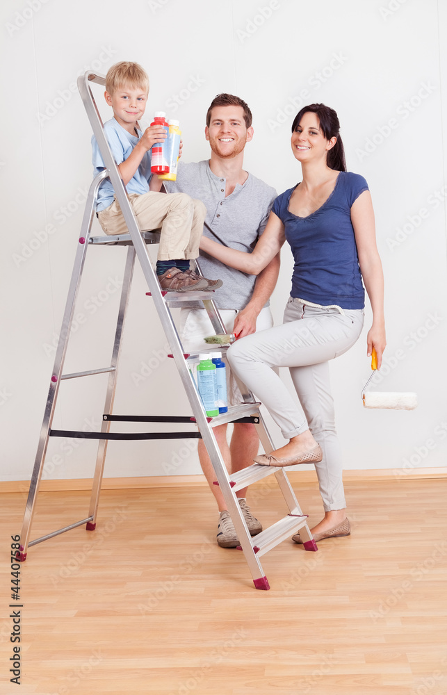 Young couple painting wall at home Young couple painting wall at home
