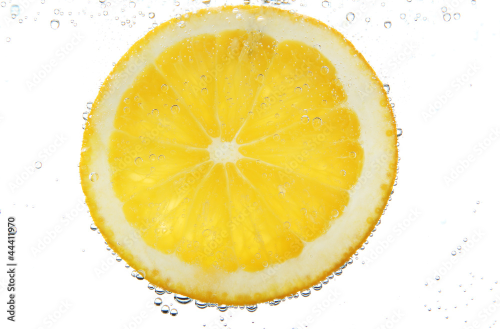 slice of orange in the water with bubbles, isolated on white
