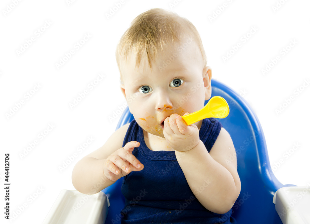 Gray-eyed child feeding spoon pumpkin puree Gray-eyed child feeding spoon pumpkin puree