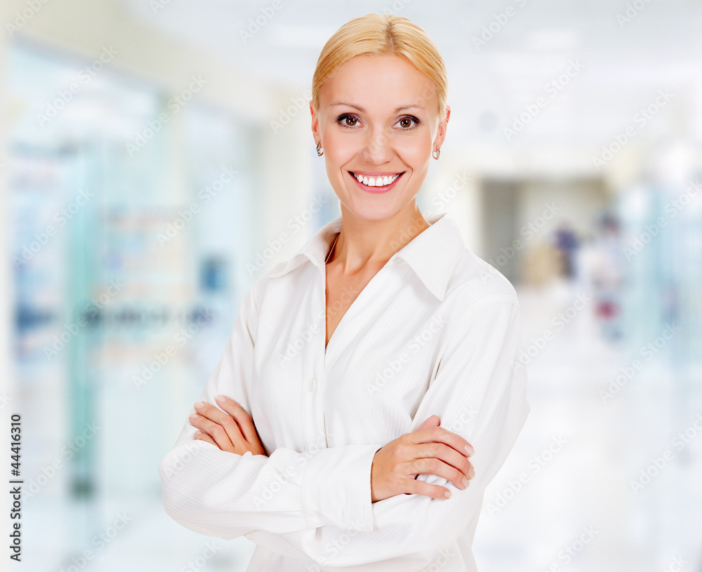 Fototapeta premium young business woman in the office smiling to you