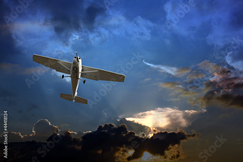 Canvas Print Small fixed wing plane against a stormy sky
