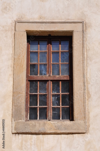 Window with steel bars on the wall of the castle